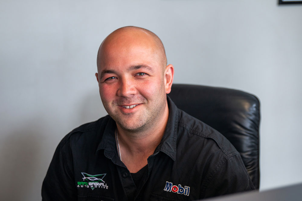 Brad smiling at the receptionist desk